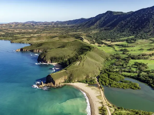 Aerial view of La Roche Percée in Bourail, with its beach in the foreground, Turtle Bay and the Three Bays walking trail.