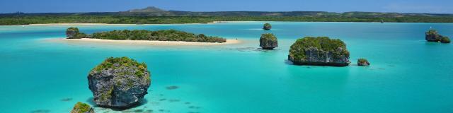 Aerial view of the turquoise lagoon of Baie d'Upi on Île des Pins, New Caledonia.