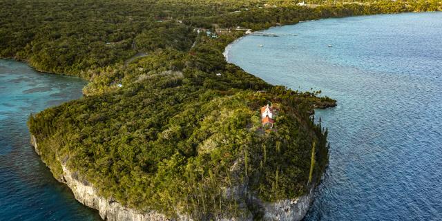 Aerial view of the Church of Notre Dame de Lourdes and the bays of Jinek and Santal in Lifou, Loyalty Islands of New Caledonia.