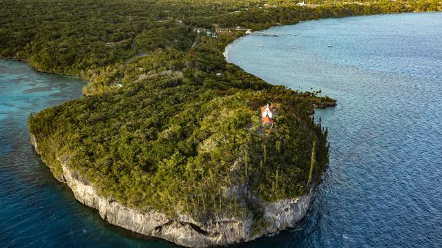 Aerial view of the Church of Notre Dame de Lourdes and the bays of Jinek and Santal in Lifou, Loyalty Islands of New Caledonia.