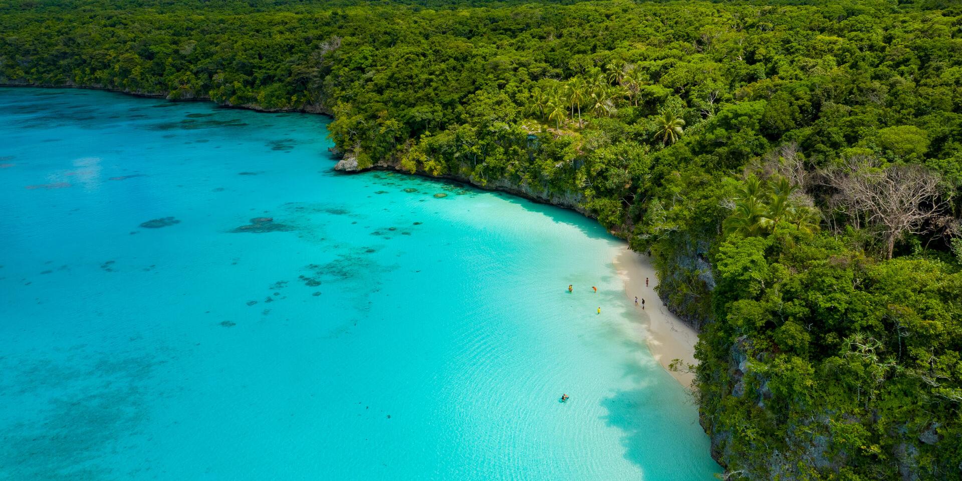 Aerial view of Kiki beach and the turquoise lagoon of Lifou, Loyalty Island, New Caledonia.