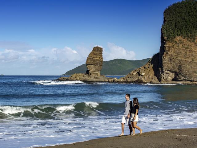 Stroll along the Roche Percée beach overlooking the Bonhomme de Bourail in New Caledonia.