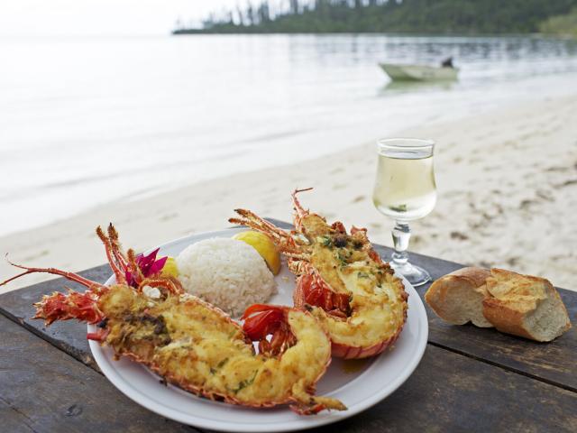 Enjoy fresh lobster on the beach at Île des Pins, New Caledonia