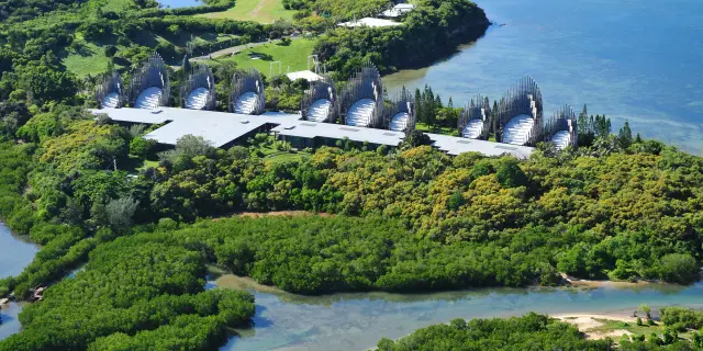 Aerial view of the Tjibaou Cultural Centre in Nouméa, set between mangroves, tropical vegetation and the lagoon.
