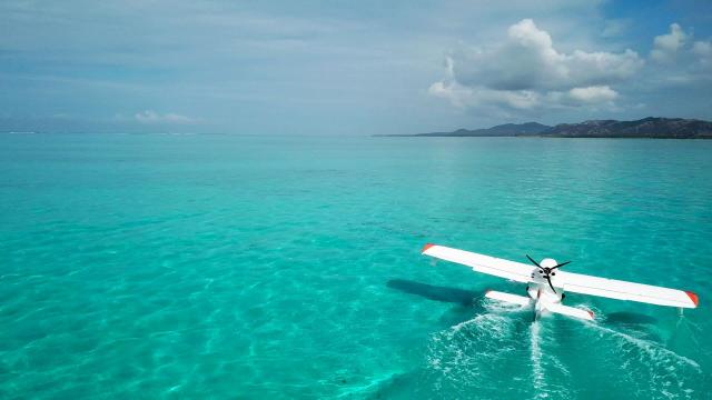 Microlight landing on Poé lagoon, New Caledonia